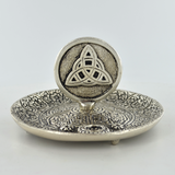 Silver coloured metal incense plate featuring a celtic symbol